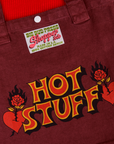 Hot Stuff Shopper Tote close up. Red Hot Stuff Text outlined with yellow. Red heart with rose piercing through on both sides of text.