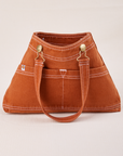 Overall Handbag in Burnt Terracotta with handle strap down across front
