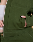 Close up of Ashley's hand in the front pocket of Heritage Mechanic Jacket in Evergreen