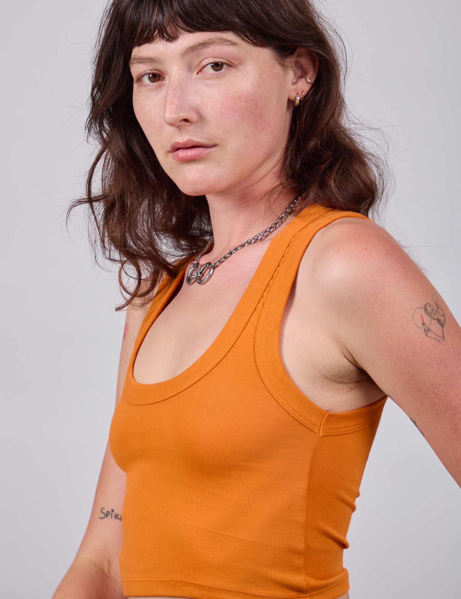 Side view close up of Cropped Tank Top in Creamsicle Orange on Alex