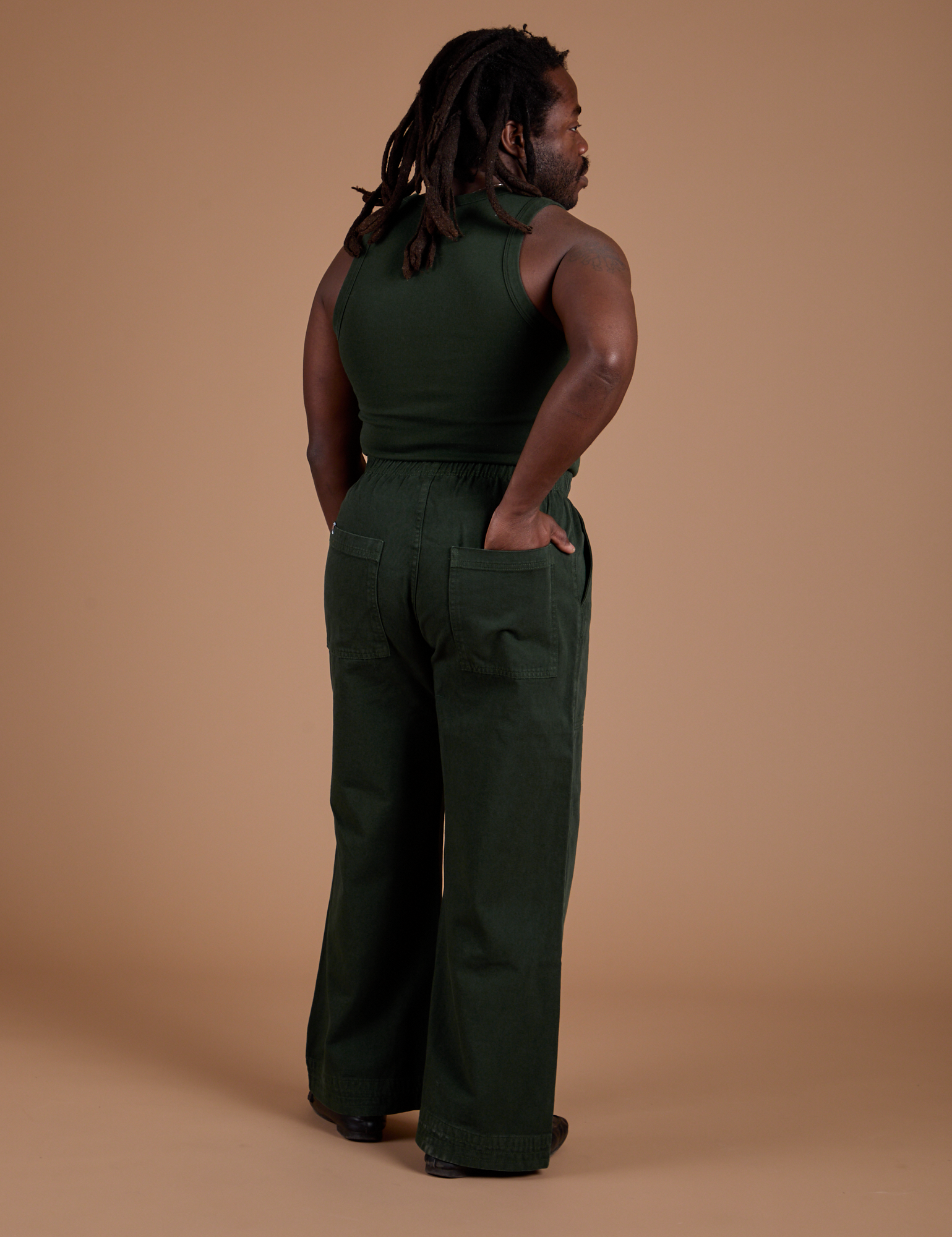 Back view of Action Pants in Swamp Green and swamp green Tank Top on Demi