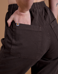 Close up of Alex's hand in the back pocket of Work Pants in Espresso Brown