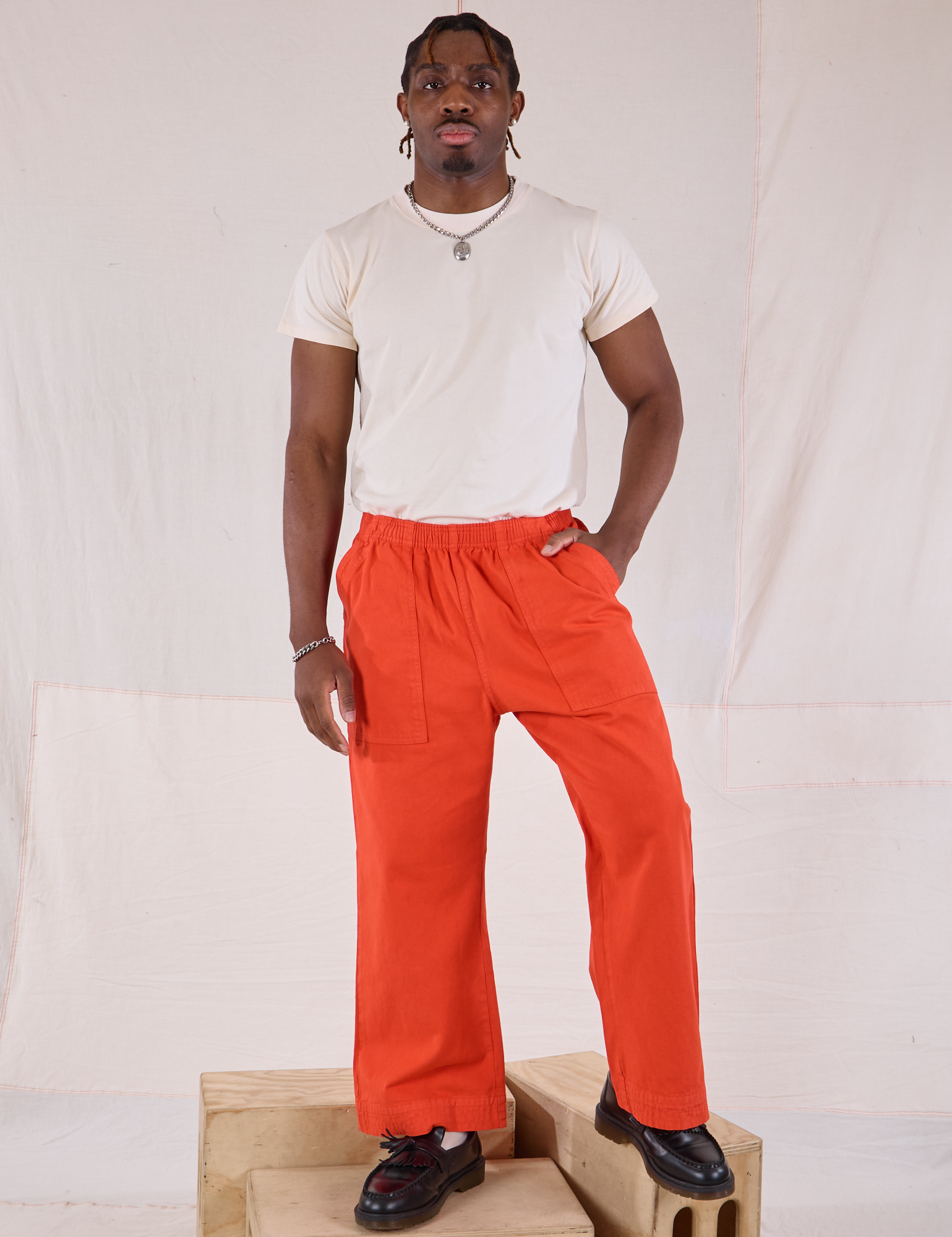 Isaac is 5&#39;10&quot; and wearing M Action Pants in Chili Red paired with Organic Vintage Tee in Vintage Tee Off-White