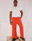 Isaac is 5'10" and wearing M Action Pants in Chili Red paired with Organic Vintage Tee in Vintage Tee Off-White