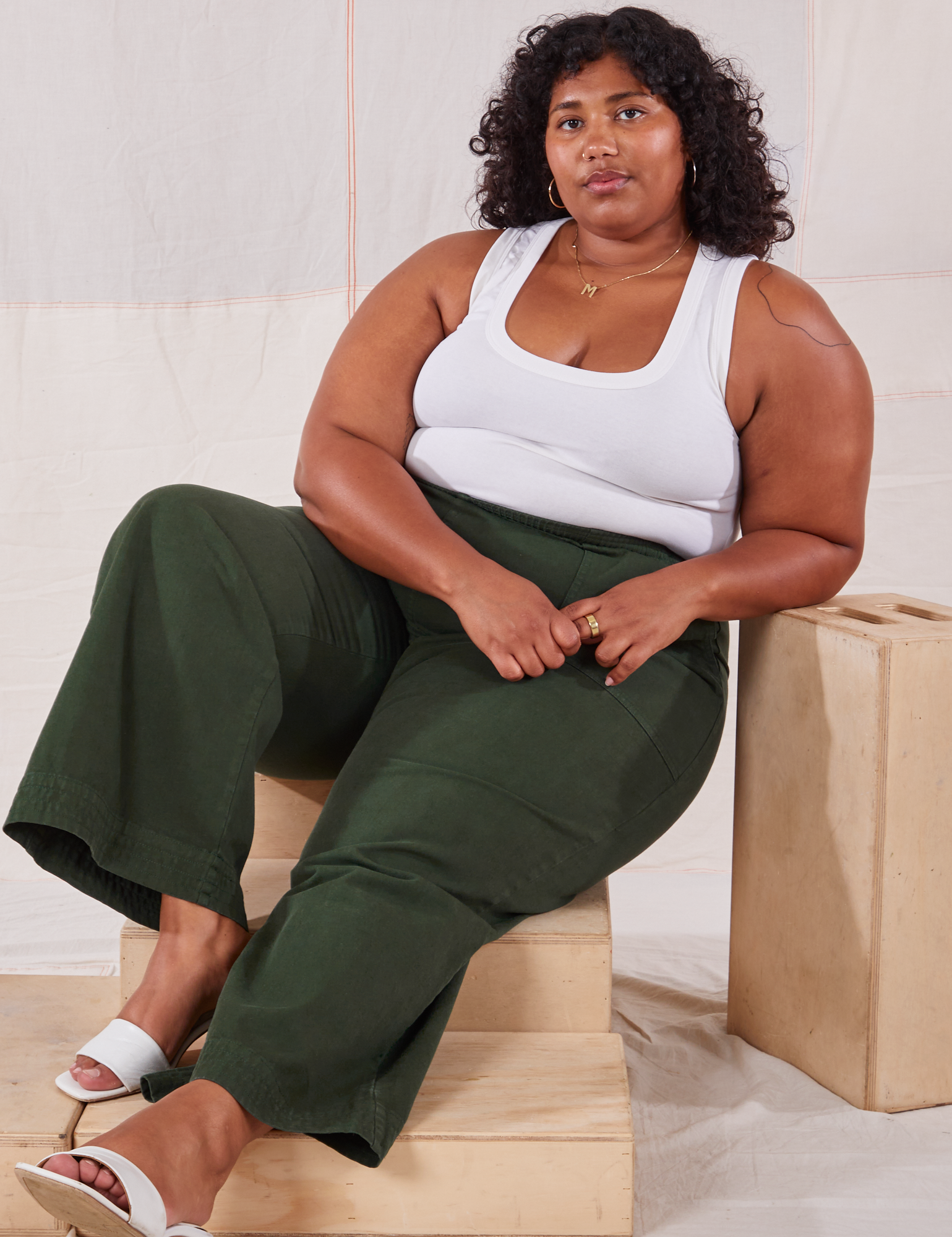 Morgan is wearing Action Pants in Swamp Green and Cropped Tank in vintage tee off-white