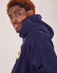 Collegiate Hoodie in Navy Blue shoulder close up on Issac