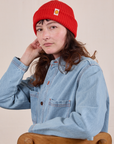 Alex is wearing the Ribbed Beanie in Mustang Red