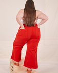 Back view of Bell Bottoms in Mustang Red on Marielena. She has her hand in both back pockets.