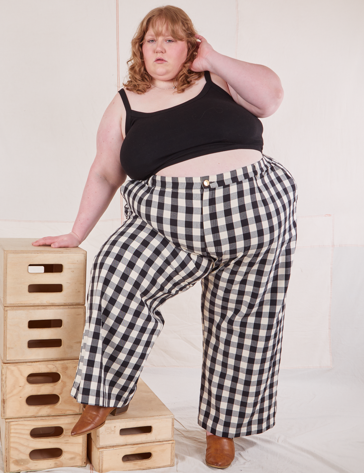 Catie is wearing Wide Leg Trousers in Big Gingham and black Cropped Cami