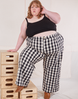 Catie is wearing Wide Leg Trousers in Big Gingham and black Cropped Cami