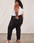 Angled back view of Work Pants in Black and Tank Top in vintage tee off-white on Morgan