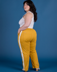 Painted Work Pants in Mustard Yellow angled back view on Ashley