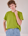 Burly Tee in Gross Green tucked into light wash Denim Wide Leg Trousers