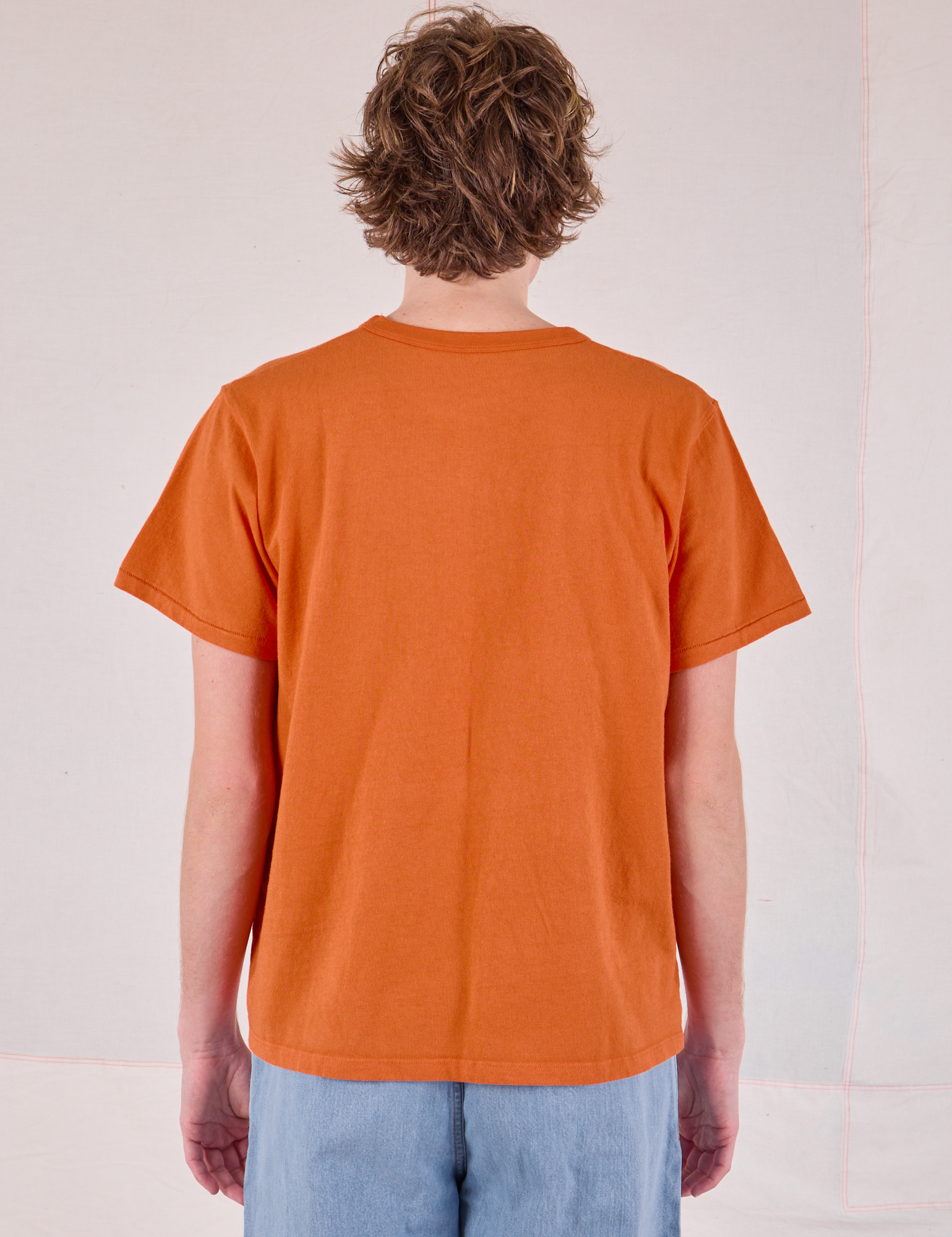 Burly Tee in Construction Orange back view on Quinn