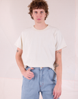 Quinn is wearing Burly Tee in Vintage Tee Off-White tucked into light wash Denim Wide Leg Trousers