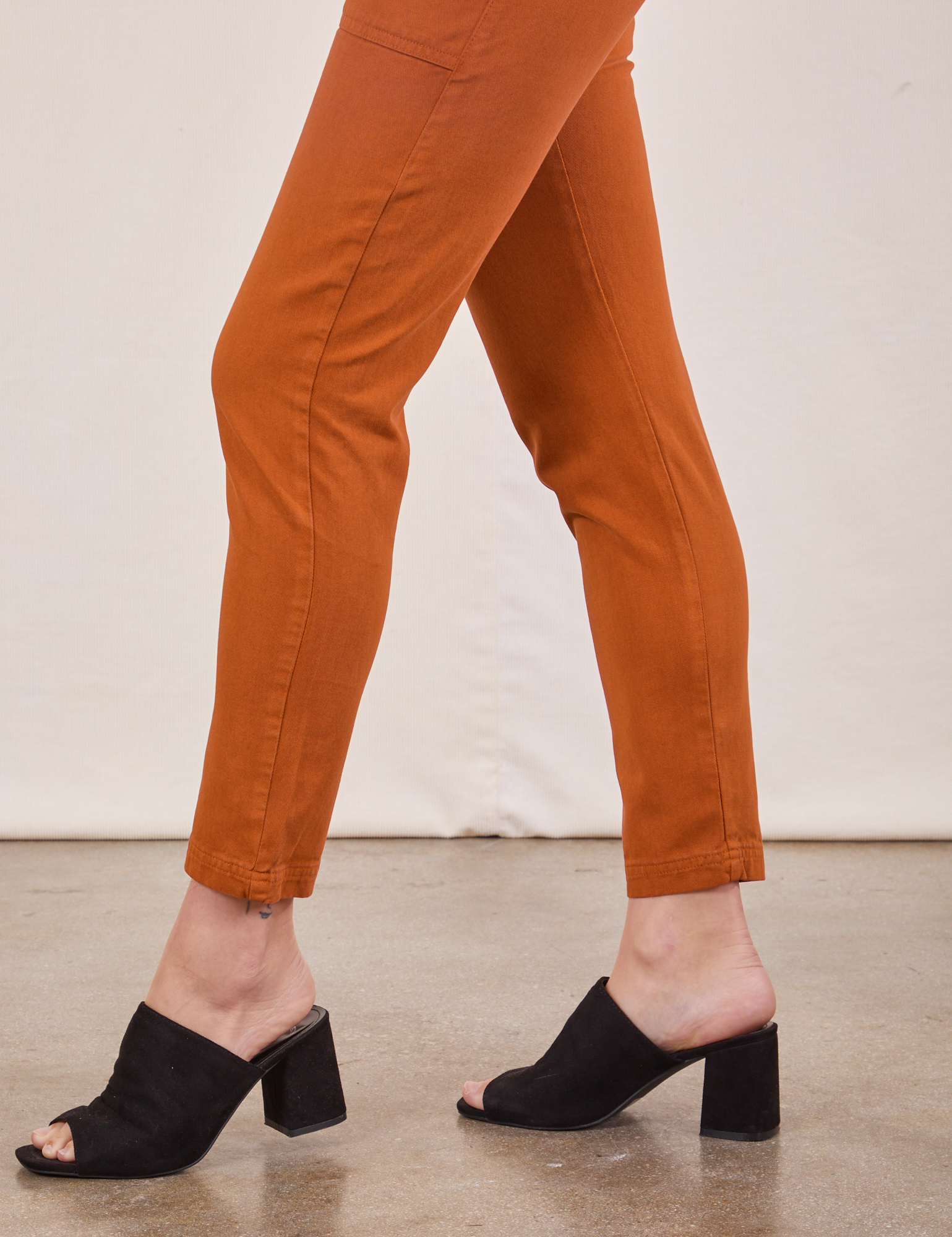 Pencil Pants in Burnt Terracotta pant leg side view close up on Alex