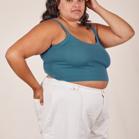 Angled view of Cropped Cami in Marine Blue and vintage off-white Western Pants worn by Alicia.