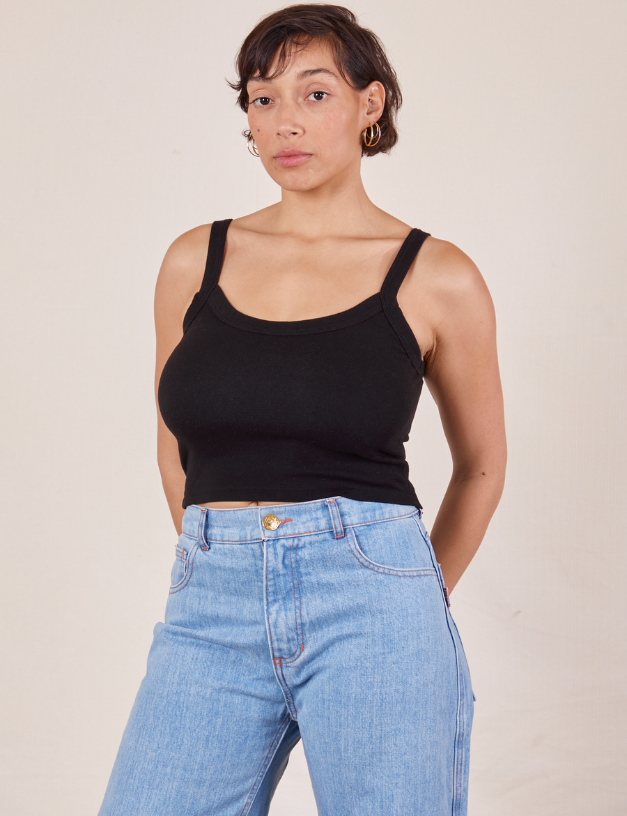 Tiara is wearing XS Cropped Cami in Basic Black paired with light wash Sailor Jeans
