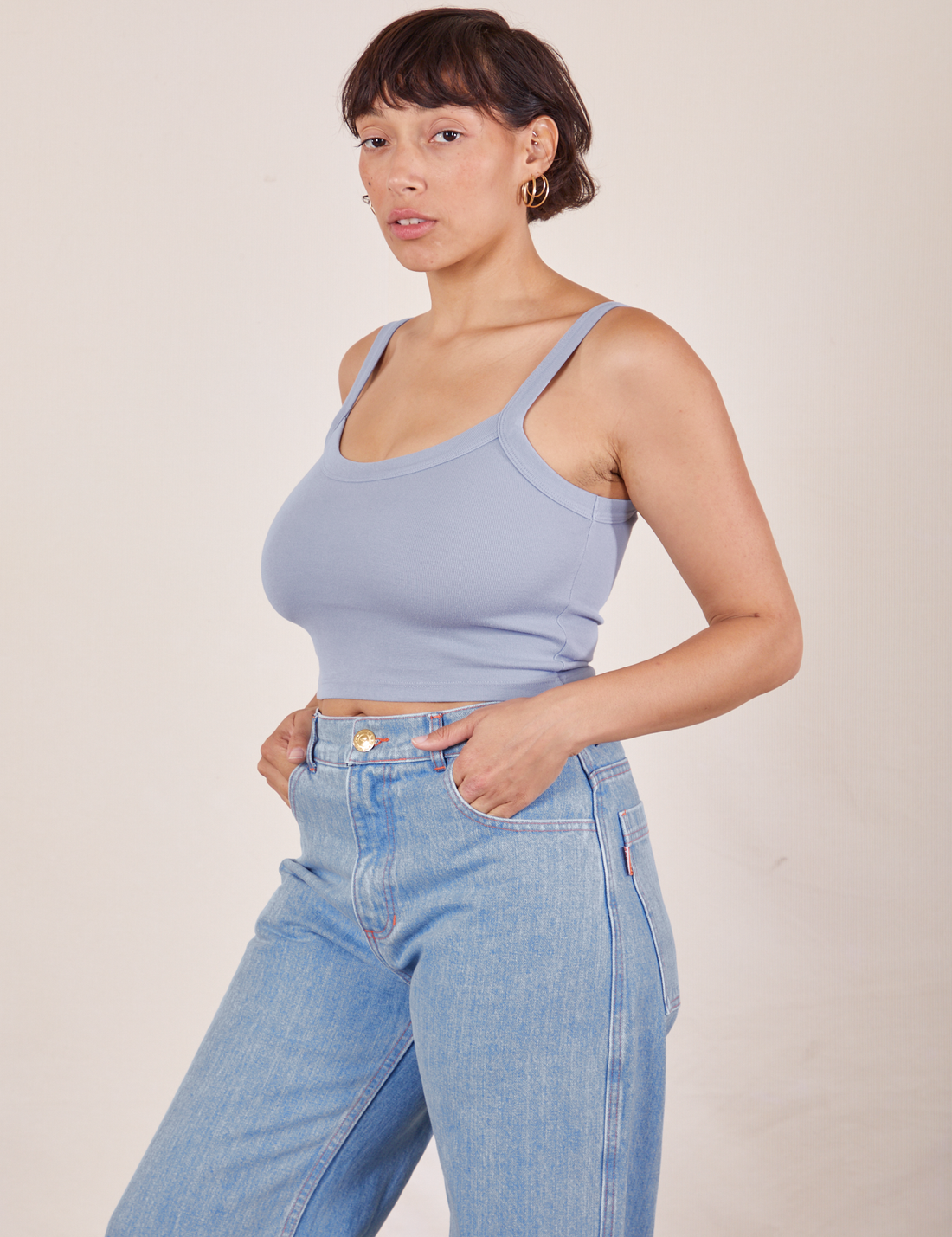 Angled view of Cropped Cami in Periwinkle and light wash Sailor Jeans worn by Tiara