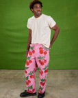 Angled front view of Cherry Paintstamped Work Pants in Bubblegum Pink and Organic Vintage Tee in Vintage Off-White