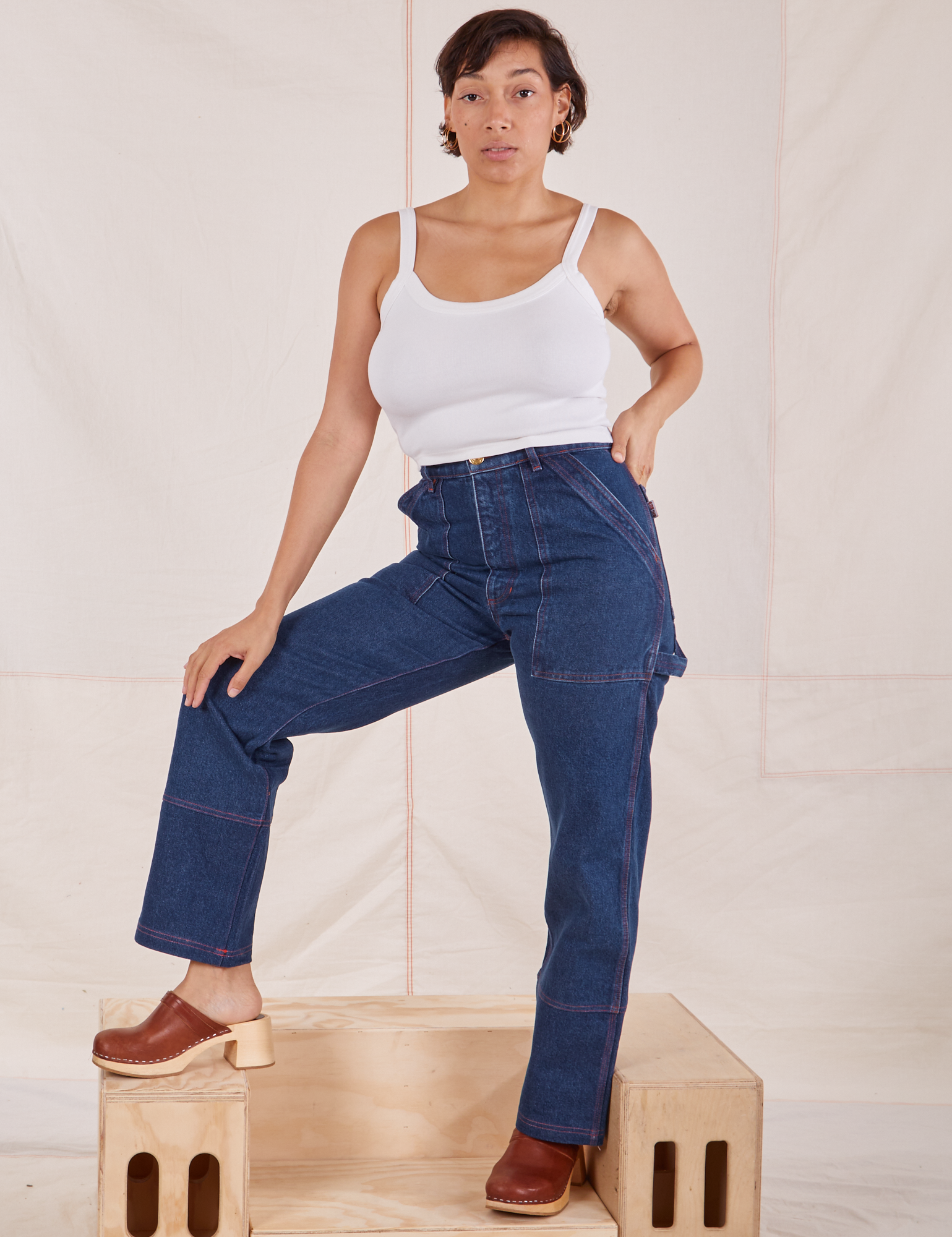 Tiara is 5&#39;4&quot; and wearing S Carpenter Jeans in Dark Wash paired with a vintage off-white Cami