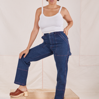 Tiara is 5'4" and wearing S Carpenter Jeans in Dark Wash paired with a vintage off-white Cami