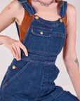 Carpenter Overalls in Dark Wash front close up on Alex