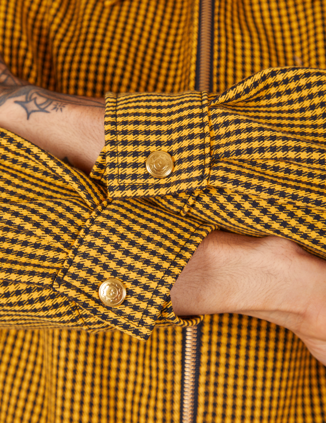 Sleeve close up of Ricky Jacket in Checker Yellow worn by Jesse