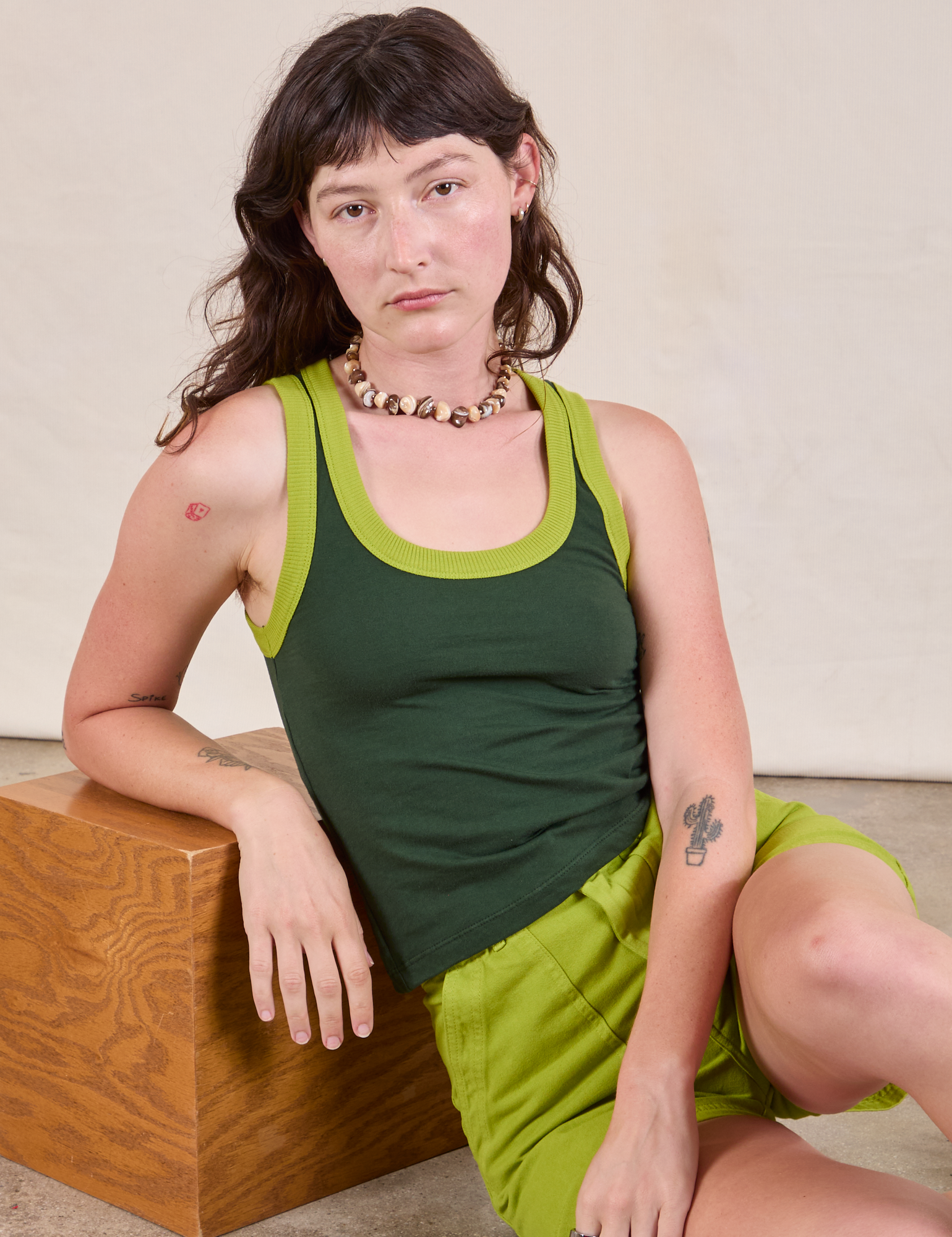 Alex is wearing Colorblock Cropped Tank in Swamp Green