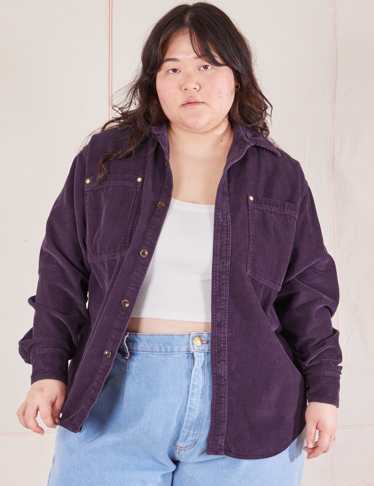 Ashley is wearing Corduroy Overshirt in Nebula Purple with a vintage off-white Cropped Cami underneath paired with light wash Denim Trouser Jeans
