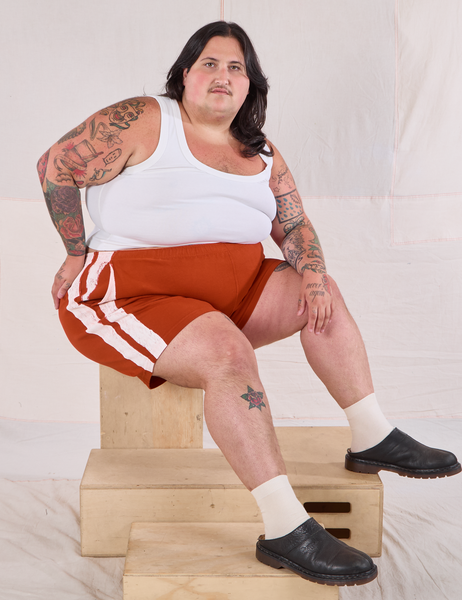 Sam is wearing Painted Stripe Easy Shorts in Paprika and Cropped Tank in Vintage Tee Off-White