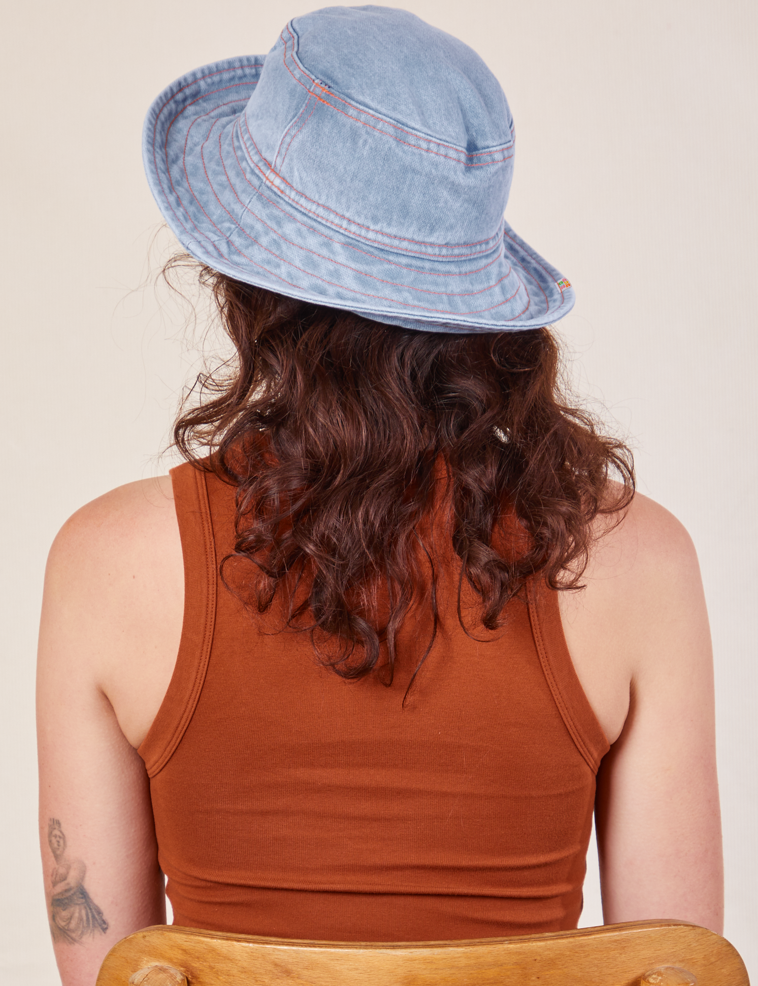 Back view of Wide Brim Denim Bucket Hat in light wash worn by Alex