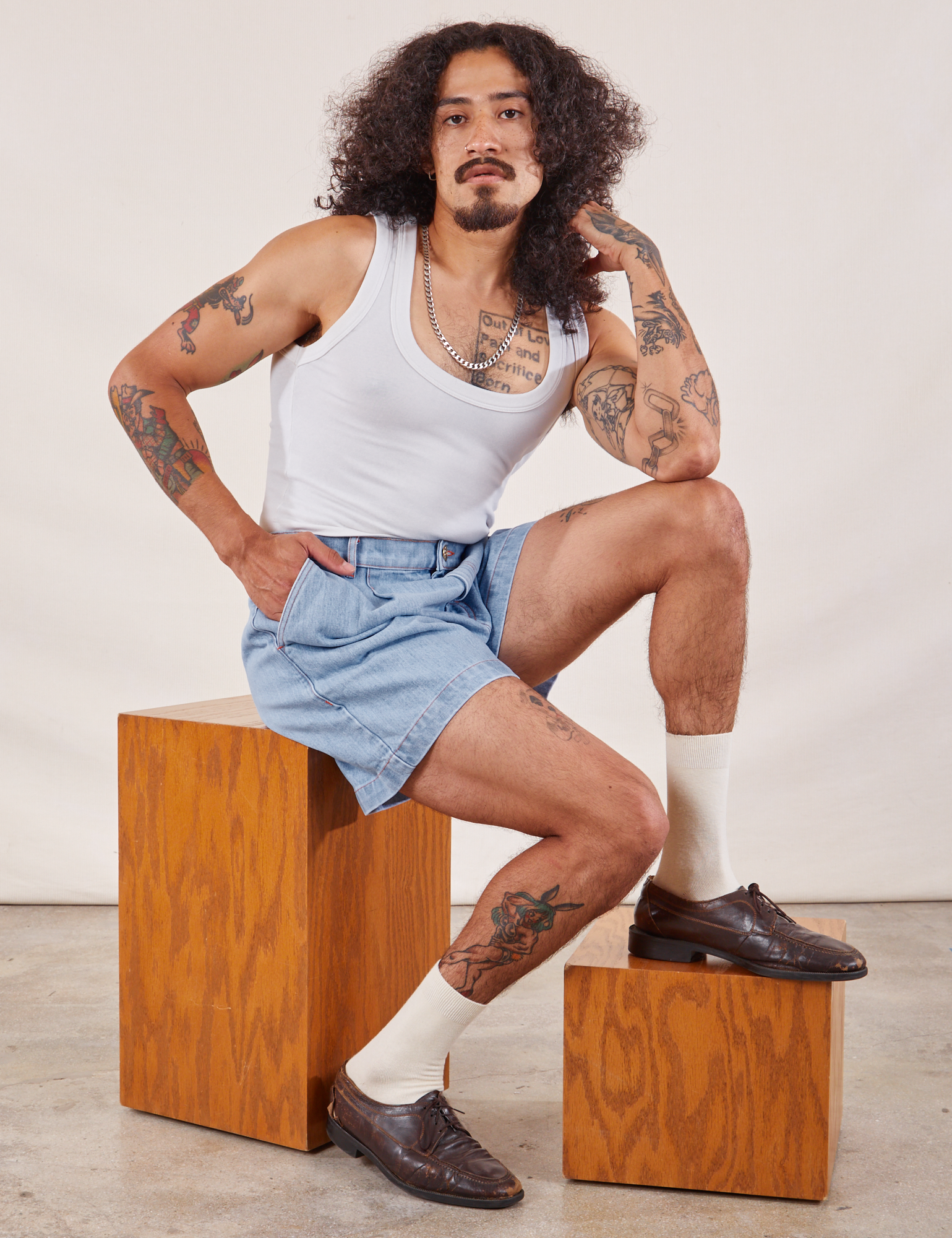 Jesse is wearing Denim Trouser Shorts in Light Wash and Cropped Tank in vintage tee off-white