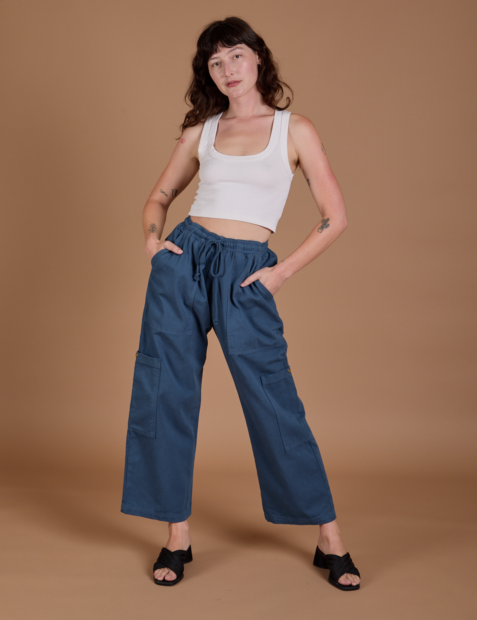 Alex is 5’8” and wearing XXS Drop Pocket Cargo Pants in French Blue paired with a Cropped Tank in vintage tee white