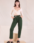 Alex is 5'8" and wearing P Easy Pants in Swamp Green paired with vintage tee off-white Wrap Top