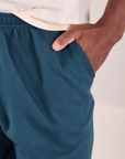 Easy Pants in Lagoon front pocket close up. Issac has his hand in the pocket.