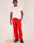 Issac is wearing Easy Pants in Mustang Red and Organic Vintage Tee in Vintage Tee Off-White