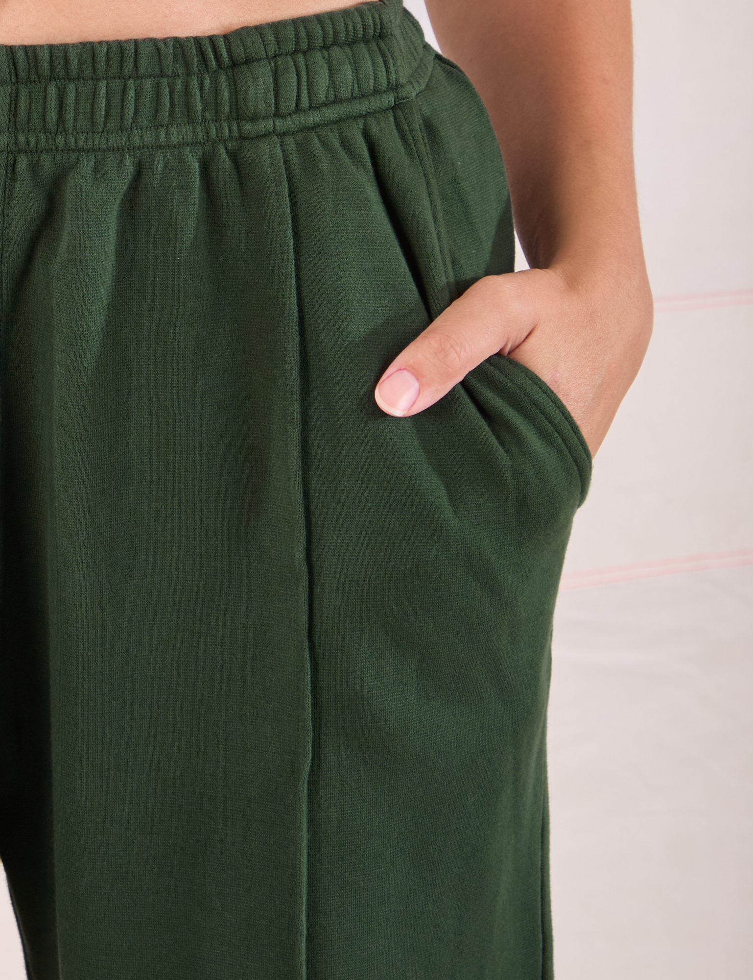 Easy Western Pants in Swamp Green close up of Tiara&#39;s hand in the pocket