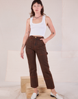 Alex is 5'8" and wearing XXS Overdyed Carpenter Jeans in Fudge paired with a Cropped Tank in vintage tee off-white