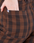 Gingham Western Pants in Fudge Brown back pocket close up. Margaret has her hand tucked into the pocket.