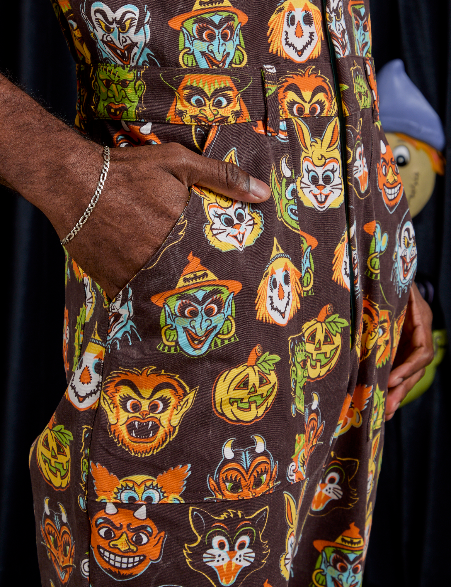 Close up of Jerrod&#39;s hand in the front pocket of Short Sleeve Jumpsuit in Halloween Masks