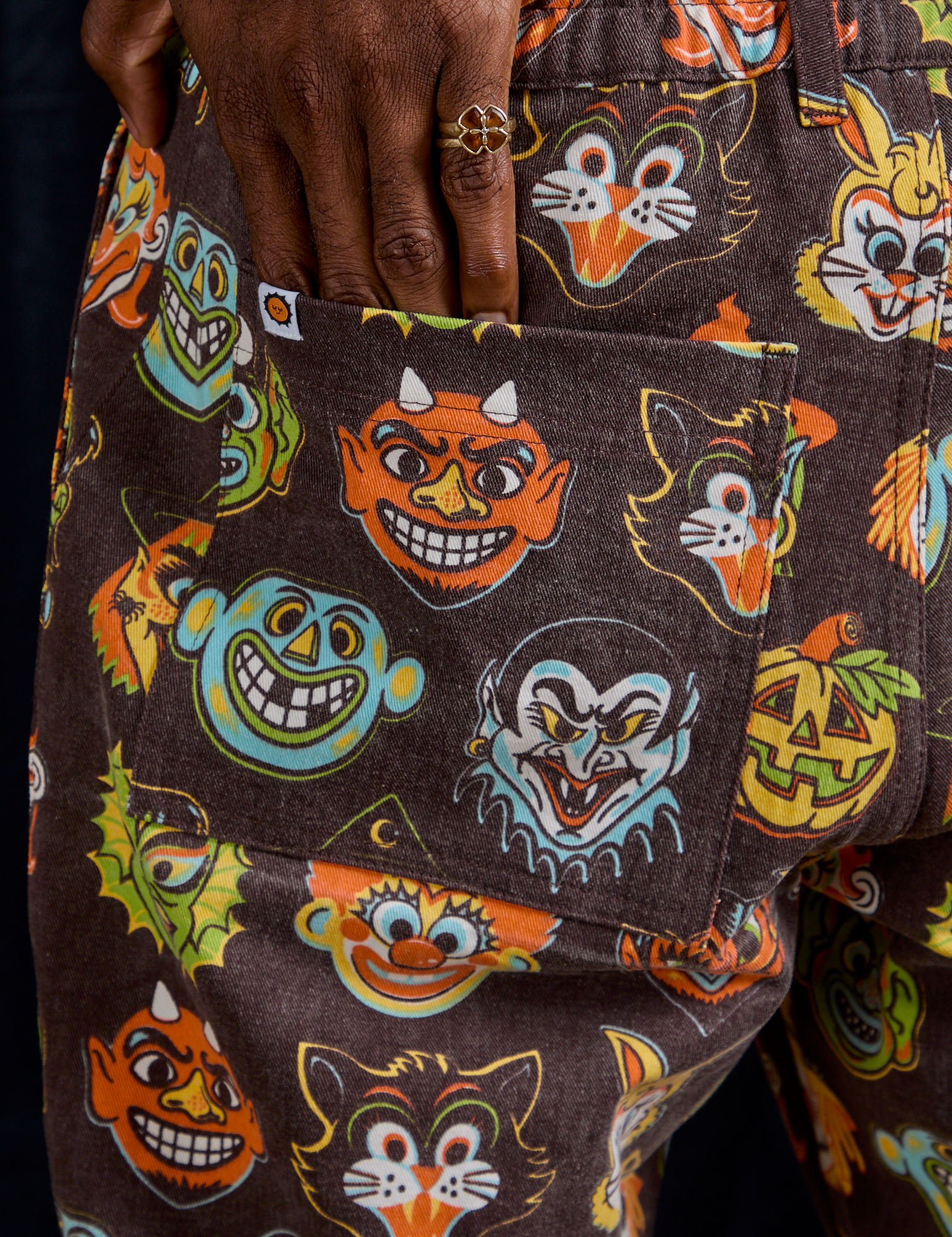 Close up of Jerrod&#39;s hand tucked into the back pocket of Work Pants in Halloween Masks