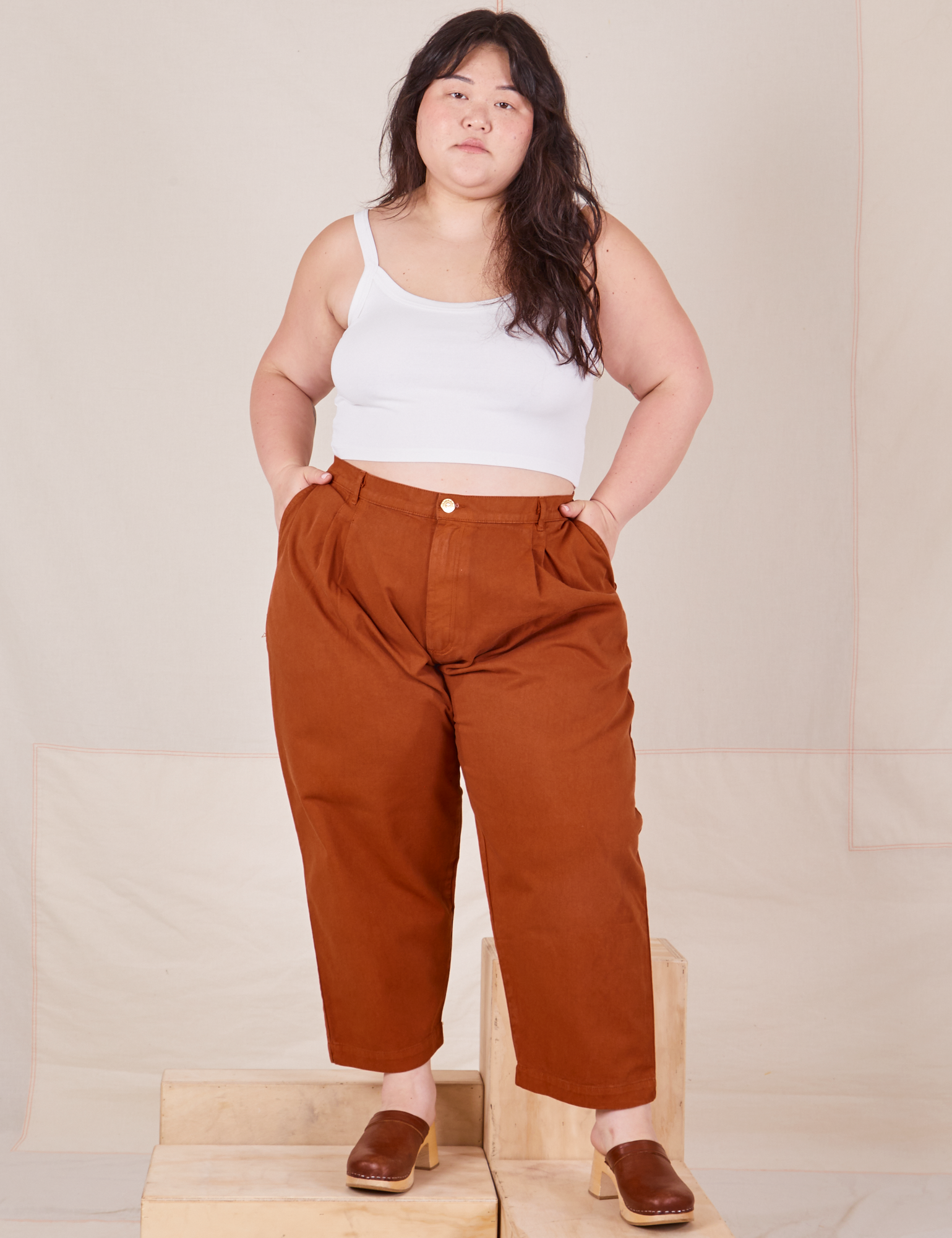 Ashley is 5&#39;7&quot; and wearing 1XL Petite Heavyweight Trousers in Burnt Terracotta paired with vintage off-white Cropped Cami