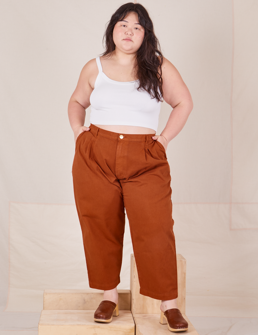 Ashley is 5'7" and wearing 1XL Petite Heavyweight Trousers in Burnt Terracotta paired with vintage off-white Cropped Cami