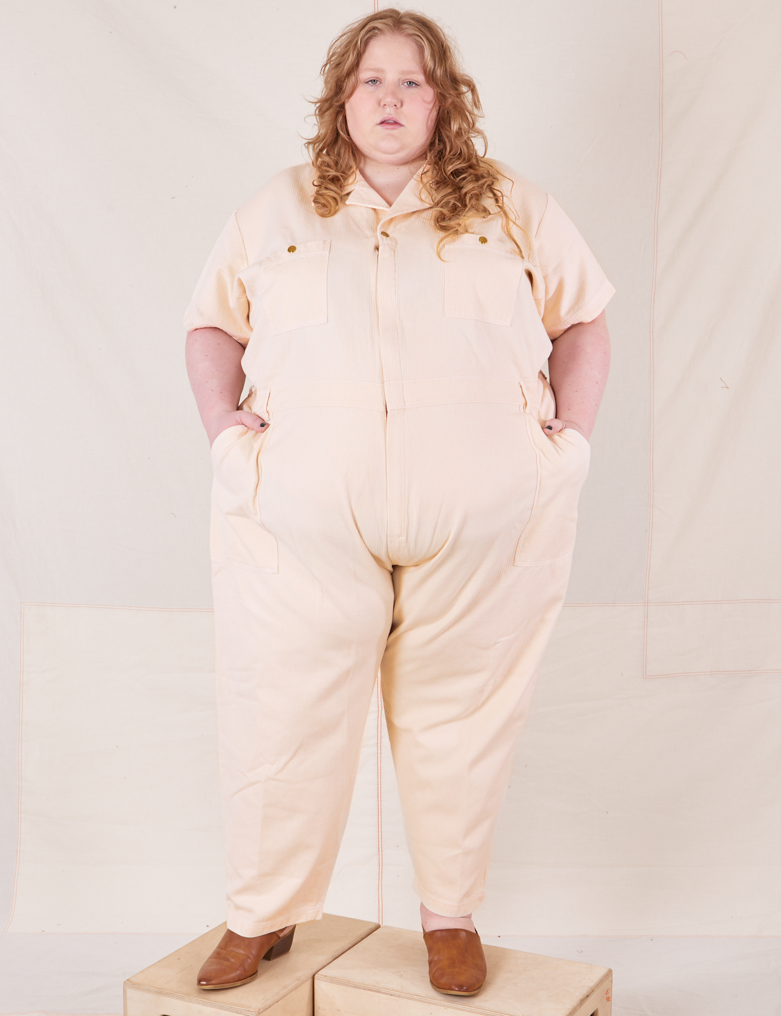 Catie is 5&#39;11&quot; and wearing size 5XL Heritage Short Sleeve Jumpsuit in Natural