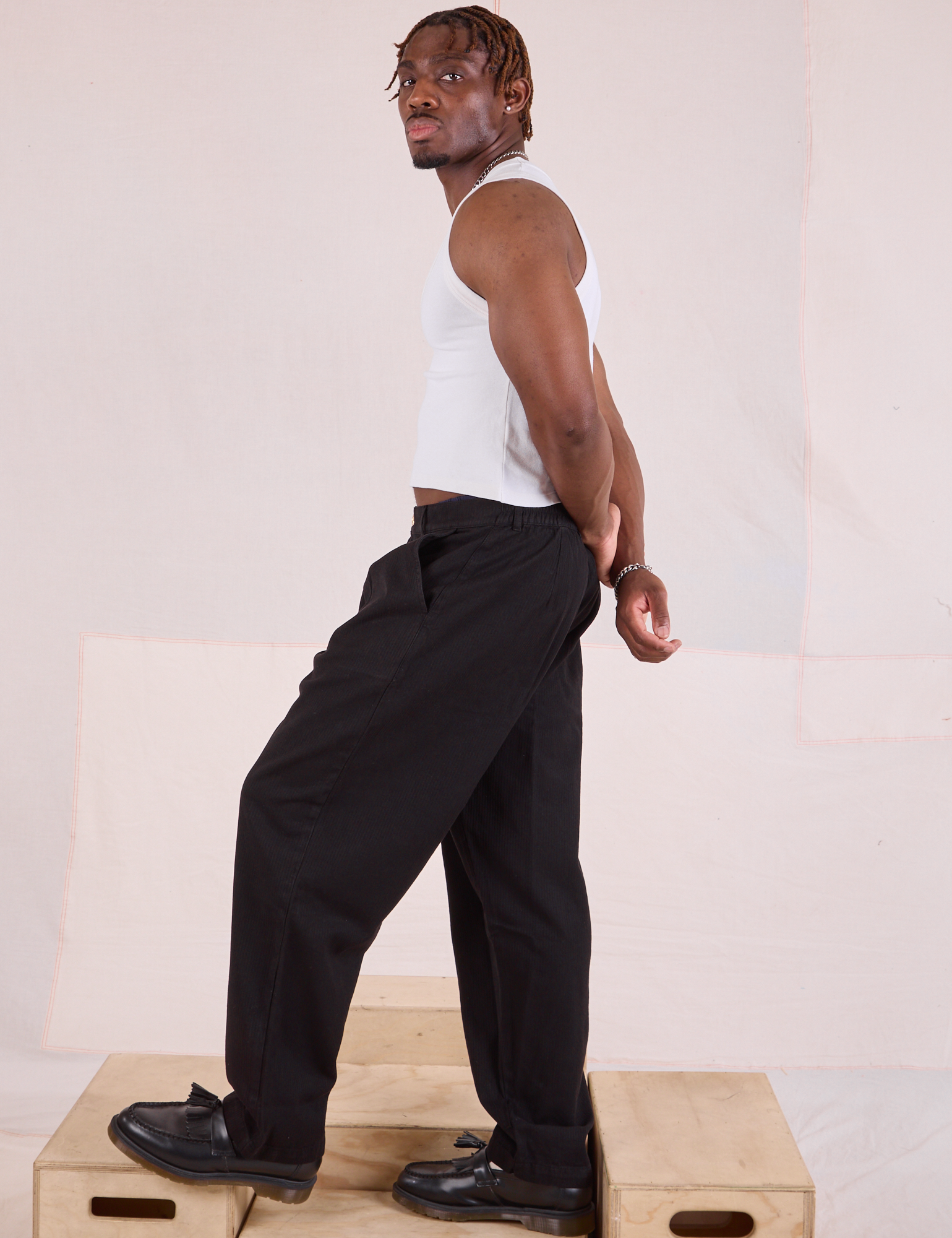 Side view of Heritage Trousers in Basic Black and Cropped Tank in vintage tee off-white on Issac