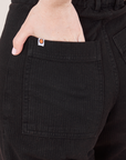 Heritage Westerns in Basic Black back pocket close up. Hana has her hand tucked into the pocket.