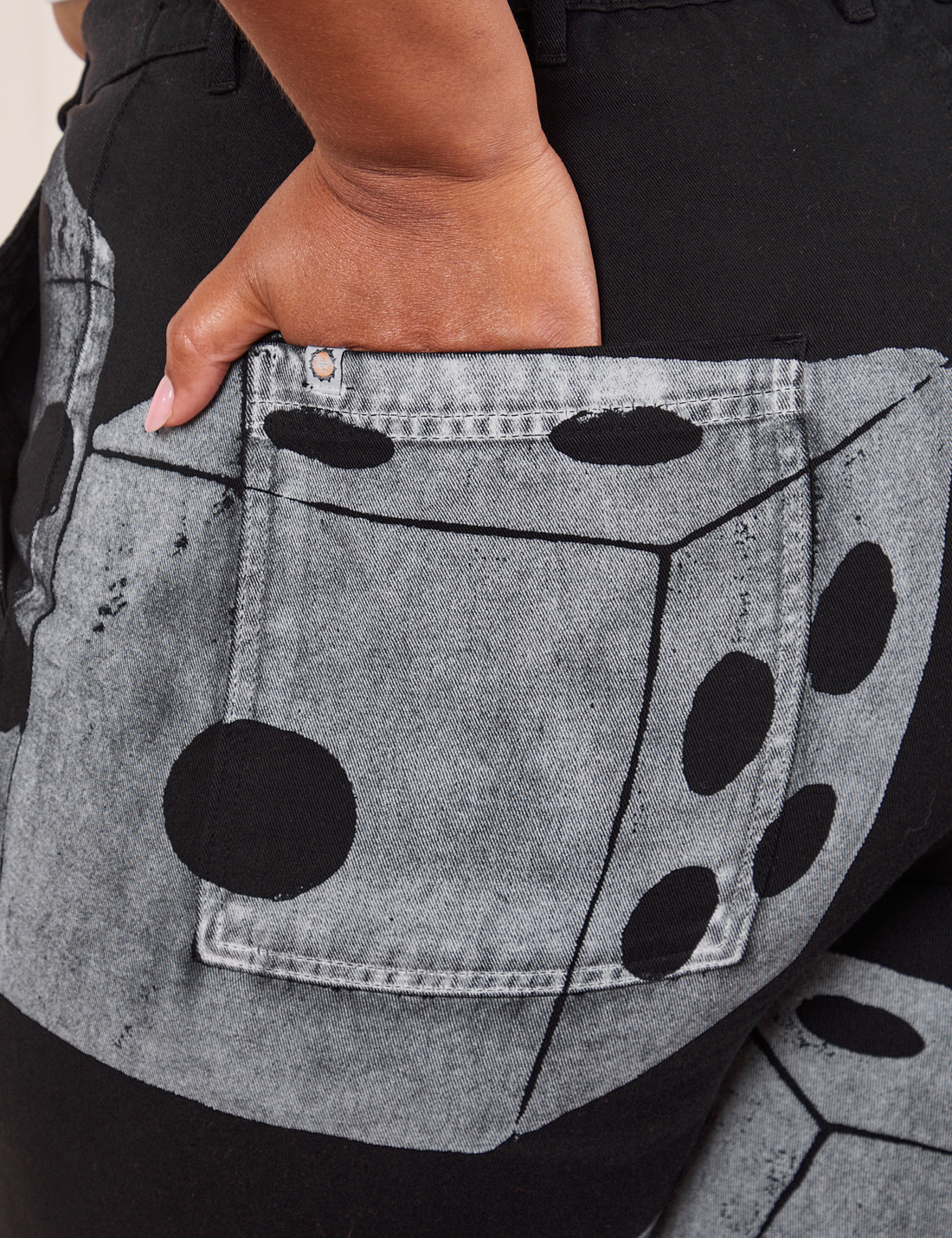 Back pocket close up of Icon Work Pants in Dice. Morgan has her hand in he pocket.