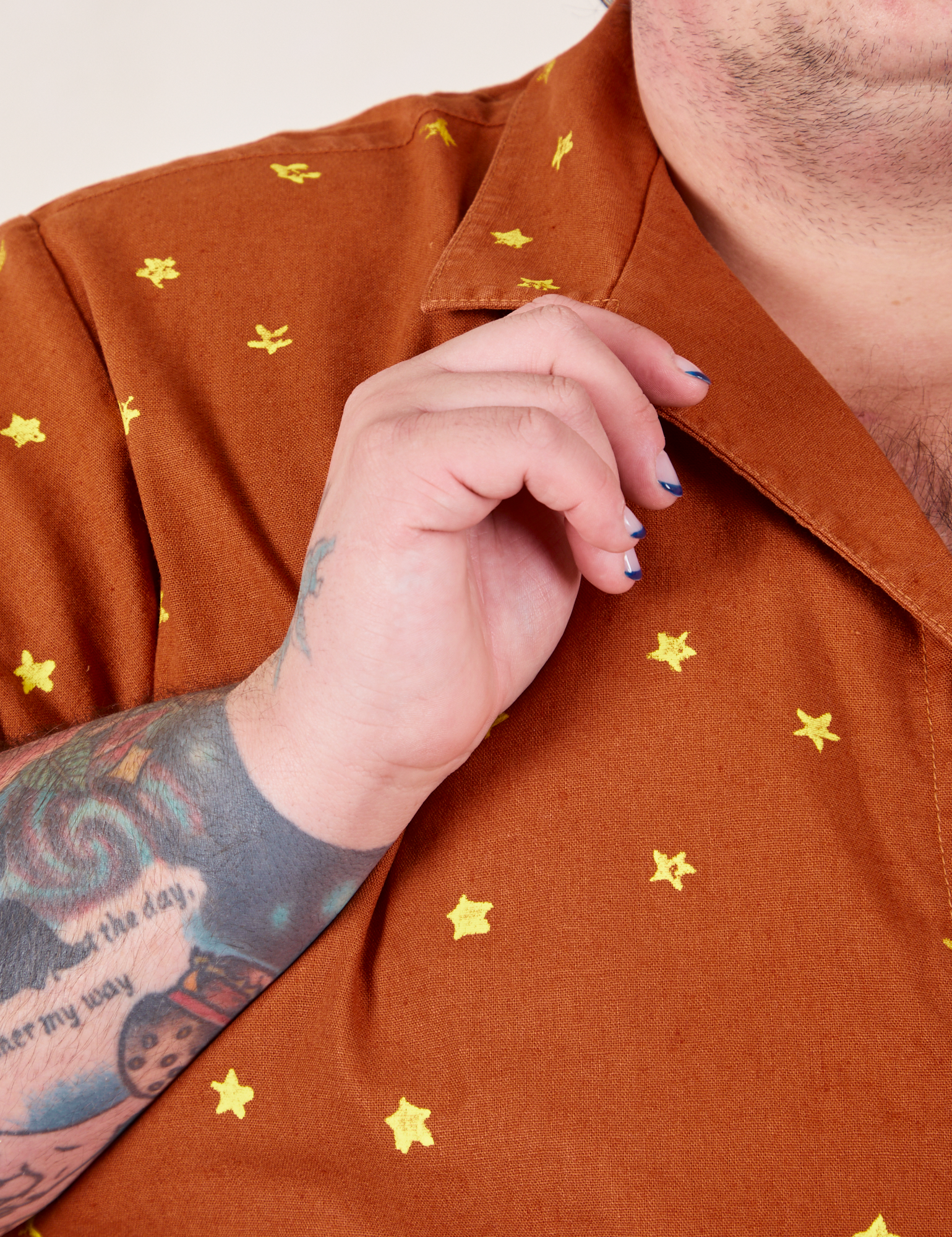 Icon Pantry Button-Up in Stars front close up. Sam is holding the collar.