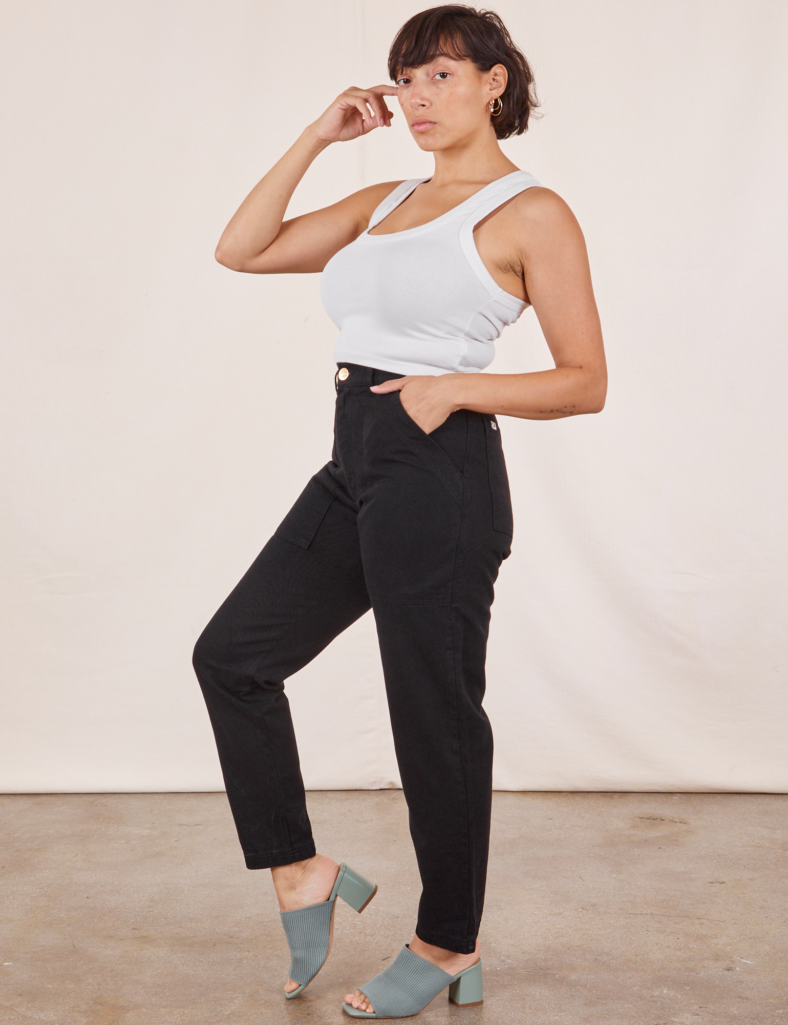 Side view of Pencil Pants in Basic Black and vintage off-white Tank Top worn by Tiara